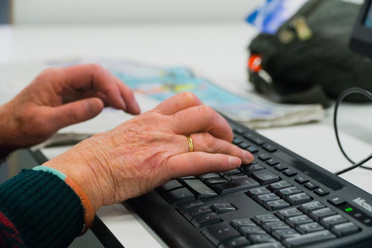 Elderly woman&#039;s hands on a keyboard