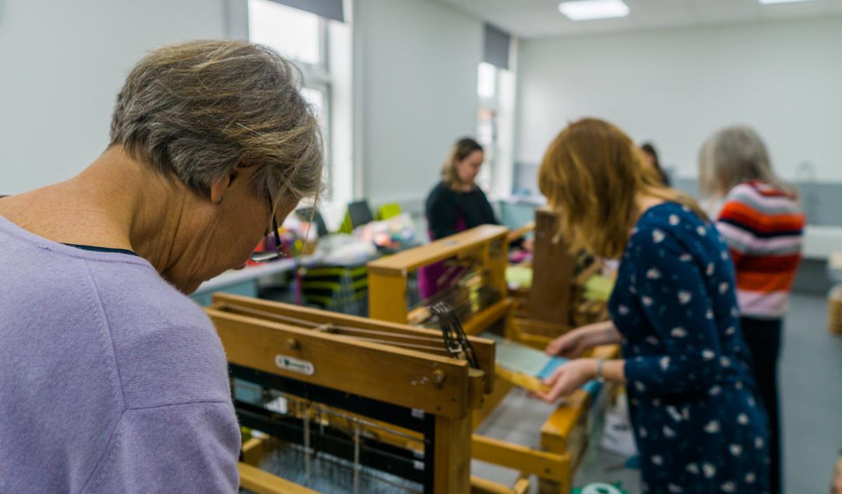 Women in a library weaving