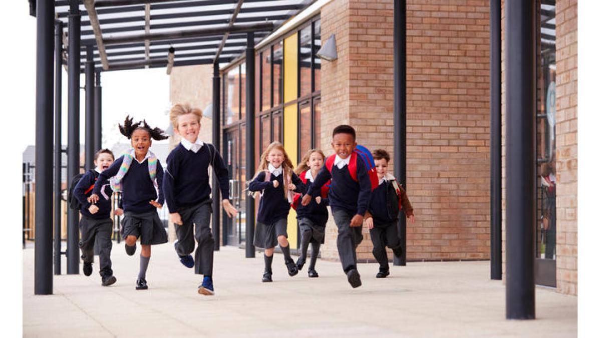 Children run towards the camera, smiling.