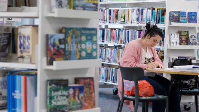 Woman sitting at desk in a library