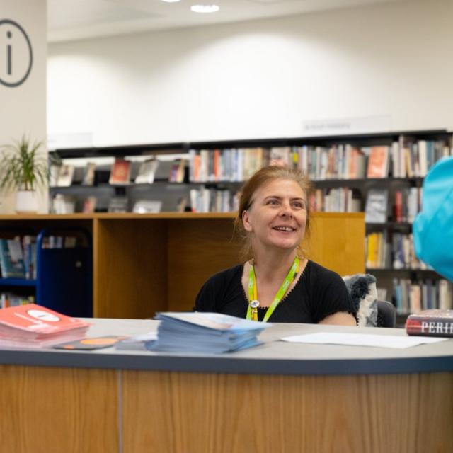 Member of staff helping member of the public