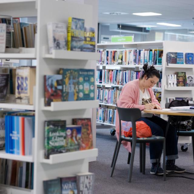 Woman sitting at desk in a library