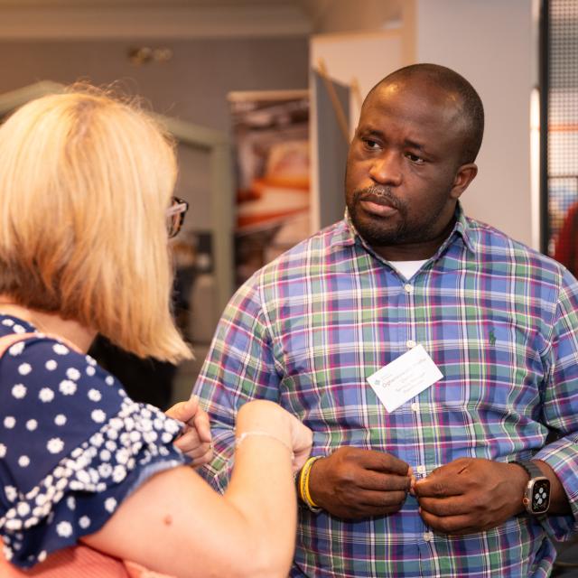 A man is engaged in conversation with a woman at the Libraries Connected annual seminar.