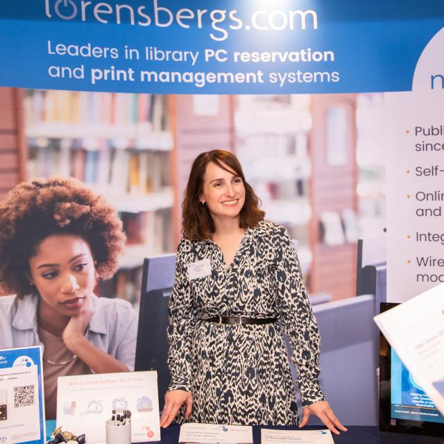 A person stood at a sponsor's stall